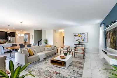 a living room with a couch and a table at Stunning 6BR Lakeview at Storey Lake next to Disney - 2929 in Kissimmee
