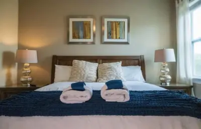 two towels are on top of a bed at Gorgeous 8BR PetFriendly at Encore Resort next to Disney - 7625 in Orlando