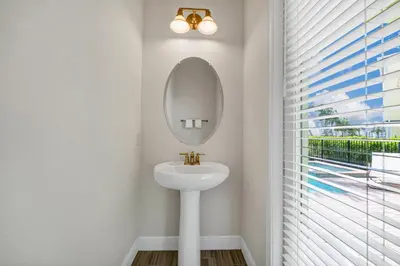 a bathroom with a sink and a mirror at The Lime Life Cottage Near Disney With Margaritaville Resort And Island H20 Waterpark Access - 8056Sh in Orlando