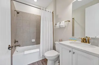 a white bathroom with a toilet and a sink at The Lime Life Cottage Near Disney With Margaritaville Resort And Island H20 Waterpark Access - 8056Sh in Orlando