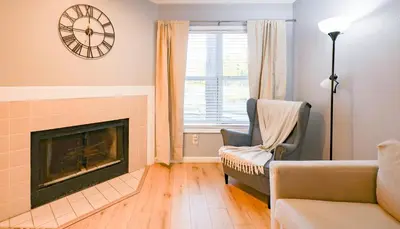 a living room with a fireplace and a clock on the wall at Disney Universal Family Resort # Pool # Gym in Orlando