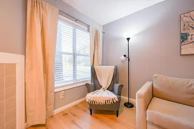 a living room with a chair and a window at Disney Universal Family Resort # Pool # Gym in Orlando