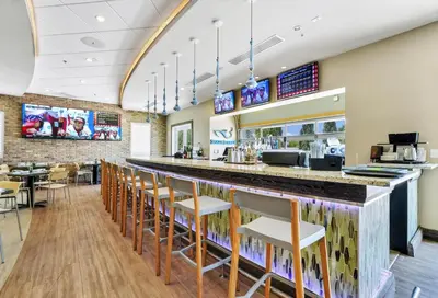a bar in a restaurant with chairs and tables at Home With Movie Theater, Game & Theme Room Near Disney With Resort & Waterpark Access - 7621Wi in Orlando