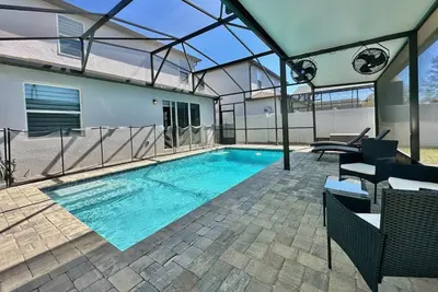 a swimming pool in the middle of a house at Charming 4 Bdr Villa near Disney in Kissimmee