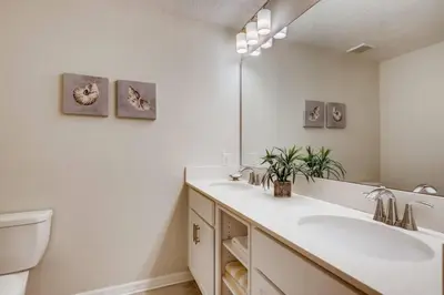 a bathroom with two sinks and a mirror at C4731-203-Storey Lake Resort Near Disney-Universal in Kissimmee