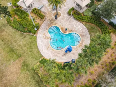 an overhead view of a swimming pool with palm trees at C4731-203-Storey Lake Resort Near Disney-Universal in Kissimmee