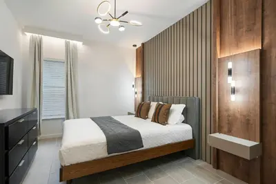 a bedroom with a bed and a ceiling fan at Orlando Paradise 5BR Themed Home in Orlando