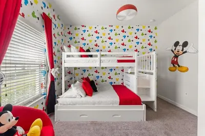 a bedroom with a white bunk bed with mickey mouse wallpaper at Casa 5Q c/ Piscina Privativa no Storey Lake in Kissimmee