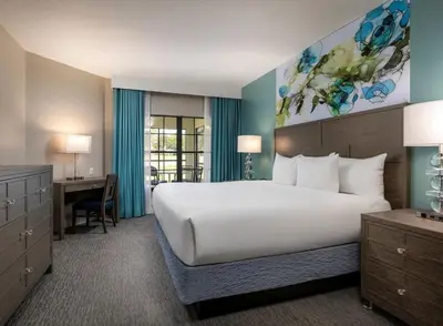 a hotel room with a large bed and a desk at Weekly rental at Orange Lake Resort for a family of 8 people in Orlando