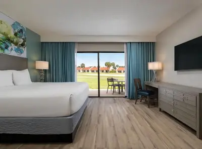 a hotel room with a bed and a television at Weekly rental at Orange Lake Resort for a family of 8 people in Orlando