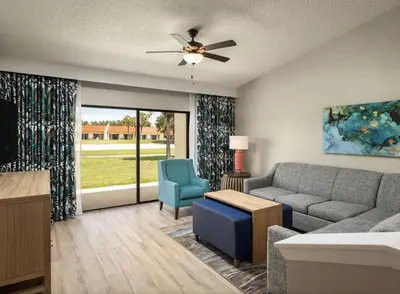 a living room with a couch and a chair at Weekly rental at Orange Lake Resort for a family of 8 people in Orlando