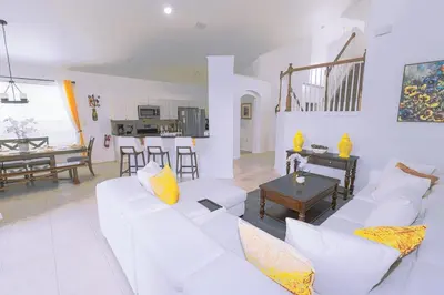 a living room with a white couch and a table at Spacious Home Perfect for Big Families in Kissimmee
