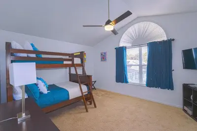 a bedroom with a bunk bed and a ceiling fan at Spacious Home Perfect for Big Families in Kissimmee