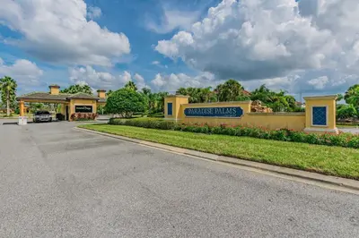 a building with a sign on the side of a road at 4Q/ Paradise Palms com Piscina Privativa in Kissimmee