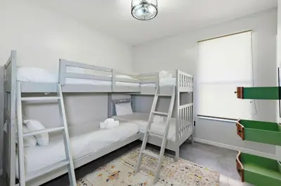 a bedroom with two bunk beds and a window at 2989 - Flamingo Farmhouse in Kissimmee