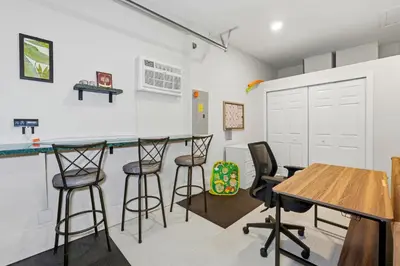 a kitchen with bar stools and a table in a room at 2989 - Flamingo Farmhouse in Kissimmee