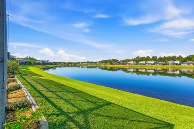a view of a river with green grass and houses at 2989 - Flamingo Farmhouse in Kissimmee