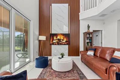 a living room with a couch and a fireplace at Comfortable 6-Bedroom Getaway Near Top Attractions in Kissimmee