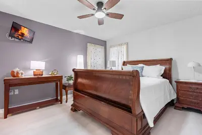 a bedroom with a bed and a ceiling fan at Comfortable 6-Bedroom Getaway Near Top Attractions in Kissimmee