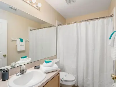 a bathroom with a sink and a toilet and a shower at Holiday Home Ferienvilla mit Garten- Grill und Terrasse by Interhome in Orlando