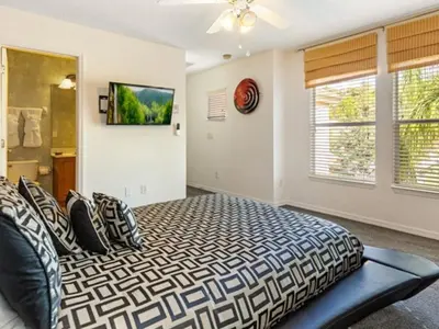 a bedroom with a bed and a television on the wall at Holiday Home Bella Vida Resort Pool und Spa Rückzugsort by Interhome in Kissimmee
