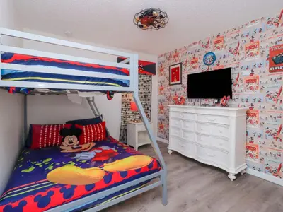 a bedroom with a bunk bed and a television at Holiday Home 4-Schlafzimmer-Ferienhaus mit Whirlpool by Interhome in Kissimmee