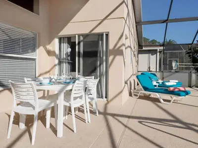 a white dining table and chairs on a balcony at Holiday Home 4-Schlafzimmer-Ferienhaus mit Whirlpool by Interhome in Kissimmee