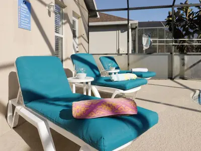 a group of blue chairs sitting on a balcony at Holiday Home 4-Schlafzimmer-Ferienhaus mit Whirlpool by Interhome in Kissimmee