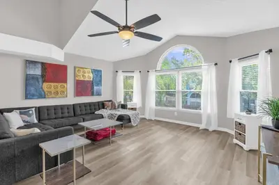 a living room with a couch and a ceiling fan at Resort Stay Near Disney Bright Gym Hot Tub in Kissimmee