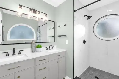 a white bathroom with a sink and a mirror at Resort Stay Near Disney Bright Gym Hot Tub in Kissimmee