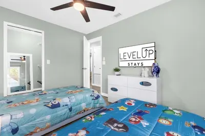 a bedroom with a bed and a ceiling fan at Resort Stay Near Disney Bright Gym Hot Tub in Kissimmee