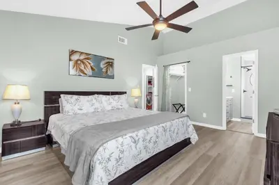 a bedroom with a bed and a ceiling fan at Resort Stay Near Disney Bright Gym Hot Tub in Kissimmee