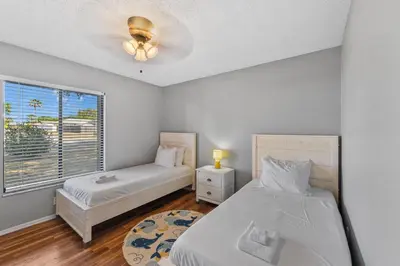 a bedroom with two beds and a window at 7694 Indian Ridge Trail S in Orlando
