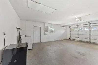an empty garage with white walls and a tv in it at 7694 Indian Ridge Trail S in Orlando