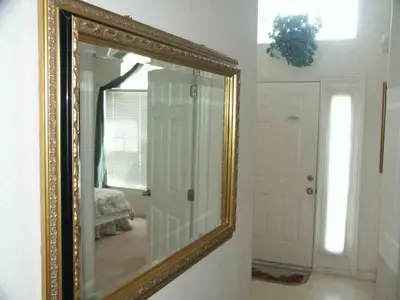 a mirror with a gold frame in a room at Lake Berkley 5 bedroom 3 bath villa near Disneyland in Kissimmee