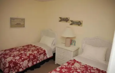 a bedroom with two beds and a lamp on a table at Lake Berkley 5 bedroom 3 bath villa near Disneyland in Kissimmee