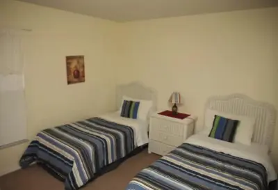 a bedroom with two beds and a table with a lamp at Lake Berkley 5 bedroom 3 bath villa near Disneyland in Kissimmee