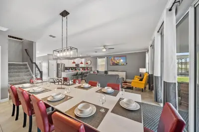 a dining room and living room with a table and chairs at 4177 Paragraph Drive in Kissimmee