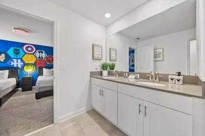 a bathroom with two sinks and a living room at 4177 Paragraph Drive in Kissimmee