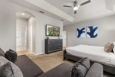 a bedroom with a bed and a tv on the wall at 4449 Shiva Loop in Kissimmee