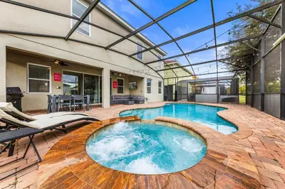 an indoor swimming pool with a glass ceiling at 4449 Shiva Loop in Kissimmee