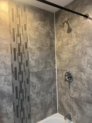 a bathroom with a shower with a sink at Condo Universal Disney Epic Free Parking in Orlando