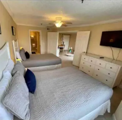 a bedroom with two beds and a flat screen tv at Condo Free Parking near Disney Universal in Orlando