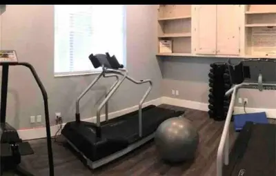 a room with a gym with a pilates ball on the floor at Condo Free Parking near Disney Universal in Orlando