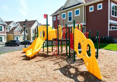 a playground with a yellow slide in a park at Townhome 3Q no Summerville com Quarto Temático in Orlando