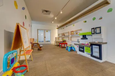 a room with a playroom with a kitchen and toys at Moana Adventure Suite Near Disney in Kissimmee