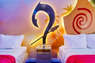 a room with two beds with a knife and a target at Moana Adventure Suite Near Disney in Kissimmee