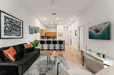 a living room with a couch and a table at Riviere Apartments King Bed Suite & Pool & Gym & Pet Friendly & Near Epic Universe in Orlando