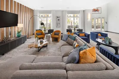 a living room with a couch and a tv at Riviere Apartments King Bed Suite & Pool & Gym & Pet Friendly & Near Epic Universe in Orlando