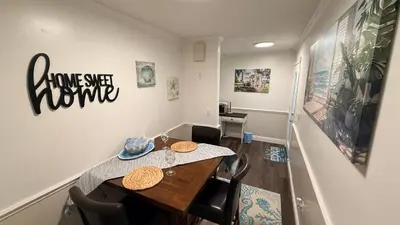 a dining room with a wooden table and chairs at The little Manatee Apartment in Orlando